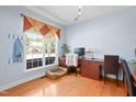Bright home office featuring wood floors, a large window, and a dedicated workspace at 534 Siltstone Pl, Cary, NC 27519