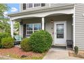 Inviting front porch with a swing, cozy bench, and manicured bushes, creating a welcoming entrance at 6001 Winged Willet Ct, Wendell, NC 27591
