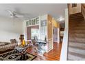 Elegant living room featuring hardwood floors, a modern ceiling fan, and stylish decor at 6001 Winged Willet Ct, Wendell, NC 27591