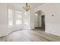 Bright dining area features large windows, modern flooring, and stylish light fixture at 616 Cheselden Dr, Durham, NC 27713