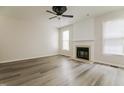 Spacious living room features a decorative fireplace, large windows, and modern ceiling fan at 616 Cheselden Dr, Durham, NC 27713