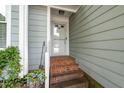 Close-up of the entryway with brick steps, showcasing the exterior design and welcoming entrance at 6213 Fountainhead Dr, Raleigh, NC 27609