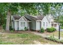 Exterior view of home with mature trees and landscaping, showing architectural details and overall property appeal at 6213 Fountainhead Dr, Raleigh, NC 27609