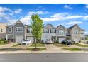 Townhome street view showcasing well-maintained lawns and attractive exteriors. Perfect for community living at 6549 Tremolo Trl, Raleigh, NC 27616