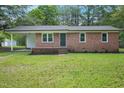 Beautiful brick home with fresh landscaping and covered porch, enhancing its curb appeal at 658 Love Grove Church Rd, Sanford, NC 27332