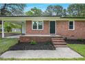 Inviting brick front porch features a covered area and new landscaping around the entrance at 658 Love Grove Church Rd, Sanford, NC 27332