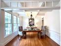 Elegant dining room with coffered ceilings, wainscoting, and a chandelier at 709 Skymont Dr, Holly Springs, NC 27540