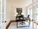 Bright office with a modern desk, neutral rug, and French doors at 709 Skymont Dr, Holly Springs, NC 27540