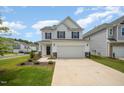 Two-story home featuring a two-car garage, landscaped yard, and welcoming front entrance at 80 Nailsworth St, Angier, NC 27501