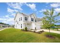 Well-maintained home boasting a spacious lawn, two-car garage, and inviting curb appeal at 80 Nailsworth St, Angier, NC 27501