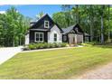 Stunning home featuring black and white accents, a lush lawn, and a welcoming porch at 88 Priscilla Ln, Fuquay Varina, NC 27526