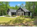 Inviting home with a well-manicured lawn, charming front porch, and lush landscaping at 88 Priscilla Ln, Fuquay Varina, NC 27526