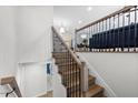 Elegant staircase features wood treads, white risers, and decorative iron railing at 947 Manchester Dr, Cary, NC 27511