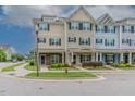 Charming exterior of townhomes with inviting front porches, colorful facades, and manicured landscaping at 996 Tender Dr, Apex, NC 27502