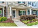 Inviting front porch with stone accents, a cozy entryway, and well-maintained landscaping at 996 Tender Dr, Apex, NC 27502