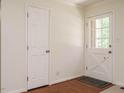 Bright entryway features hardwood floors, a glass-paneled door, and a neutral color palette at 100 Upton Ct, Garner, NC 27529