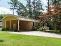 Beautiful home with a carport and attractive brickwork, complemented by a well-kept lawn at 100 Upton Ct, Garner, NC 27529