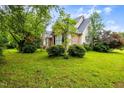 Manicured lawn and landscaping surround this beautiful home at 1016 Pasture View Ln, Raleigh, NC 27603
