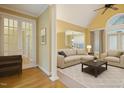 Bright living room with vaulted ceiling, hardwood floors, and neutral decor, virtually staged at 1016 Pasture View Ln, Raleigh, NC 27603