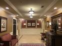 Elegantly decorated hallway with comfortable seating, artwork, and sconce lighting at 10411 Rosegate Court # 6, Raleigh, NC 27617