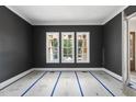 Room with dark gray walls, white trim, three windows, and a doorway visible on the right at 1225 Dixie Trl, Raleigh, NC 27607