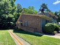 Two-story brick and siding home with a wheelchair ramp and manicured landscaping beneath a clear sky at 1306 Oakridge Ave, Henderson, NC 27536