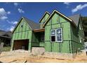 Two-story home construction showing exterior framework, brick foundation and a garage space, all under a clear blue sky at 152 Big Bradley Dr, Wendell, NC 27591