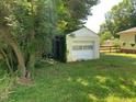 Detached garage offers additional storage space for vehicles and equipment, surrounded by greenery at 1806 Rendall St, Burlington, NC 27215