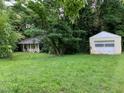 Expansive yard featuring the home and a detached garage providing ample space and storage at 1806 Rendall St, Burlington, NC 27215