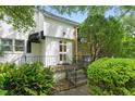 Charming two-story home with a stone facade, complemented by lush landscaping and a welcoming entrance at 1904 Smallwood Dr, Raleigh, NC 27605