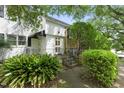 Charming two-story home with a stone facade, complemented by lush landscaping and a welcoming entrance at 1904 Smallwood Dr, Raleigh, NC 27605