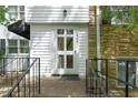 Close up of front door with black railing and stone facade at 1904 Smallwood Dr, Raleigh, NC 27605