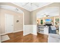Open-concept living area with hardwood floors, fireplace, and elegant archways to the dining area at 210 Water Oak Way, Louisburg, NC 27549