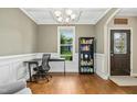 Bright office space with coffered ceilings, hardwood floors, and a large window offering plenty of natural light at 210 Water Oak Way, Louisburg, NC 27549