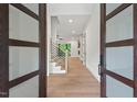 Bright foyer featuring a modern staircase and beautiful hardwood floors at 2124 Country Air Ln, Hillsborough, NC 27278