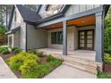 This charming covered porch features stone accents and a natural wood ceiling at 2124 Country Air Ln, Hillsborough, NC 27278