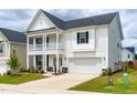 Charming two-story home featuring a double front porch and a well-maintained lawn at 222 Oak Branch - Lot 72 Trl, Garner, NC 27529