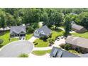 Aerial view of an upscale neighborhood and a home with a large, manicured lawn at 2333 Grey Gables Dr, Burlington, NC 27215