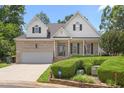 Beautiful home with a brick facade, trimmed bushes, and an attached two car garage at 2333 Grey Gables Dr, Burlington, NC 27215