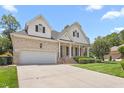 Two story home with an attached two-car garage and well manicured front lawn and mature trees at 2333 Grey Gables Dr, Burlington, NC 27215