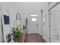 Bright foyer with hardwood floors, high ceilings, and elegant decor at 236 Lucky Ribbon Ln, Holly Springs, NC 27540