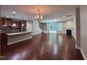 Spacious living room connected to a modern kitchen with hardwood floors and a cozy fireplace at 238 Alamosa Pl, Cary, NC 27519