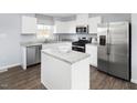 Stylish kitchen featuring white cabinets, stainless steel appliances, and a center island at 290 Grand Silo Rd, Raleigh, NC 27603