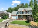 Beautiful brick home featuring a well-maintained lawn, mature trees, and a classic design at 2925 Dargan Hills Dr, Wake Forest, NC 27587