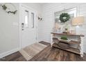 Welcoming foyer with shiplap accent wall and hardwood floors at 301 Porter Hill Dr, Youngsville, NC 27596
