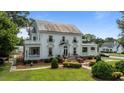 Beautiful two-story home with front balconies, a well-manicured lawn and a covered front porch at 309 W Divine St, Dunn, NC 28334