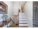 Inviting entryway featuring hardwood floors, staircase to the second level, and access to a finished basement at 315 Allister Dr, Raleigh, NC 27609