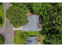 Aerial view of a home showcasing its roof, surrounding trees, and proximity to a nearby street at 3400 Appling Way, Durham, NC 27703