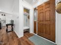 Inviting entryway with wood flooring, a wooden front door, and a convenient coat closet at 3400 Appling Way, Durham, NC 27703