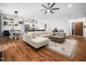 Open-concept living room with hardwood floors, a ceiling fan, and plenty of natural light at 3400 Appling Way, Durham, NC 27703